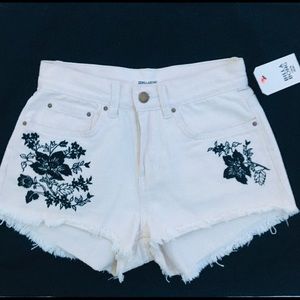 White Billabong shorts with navy blue flowers.